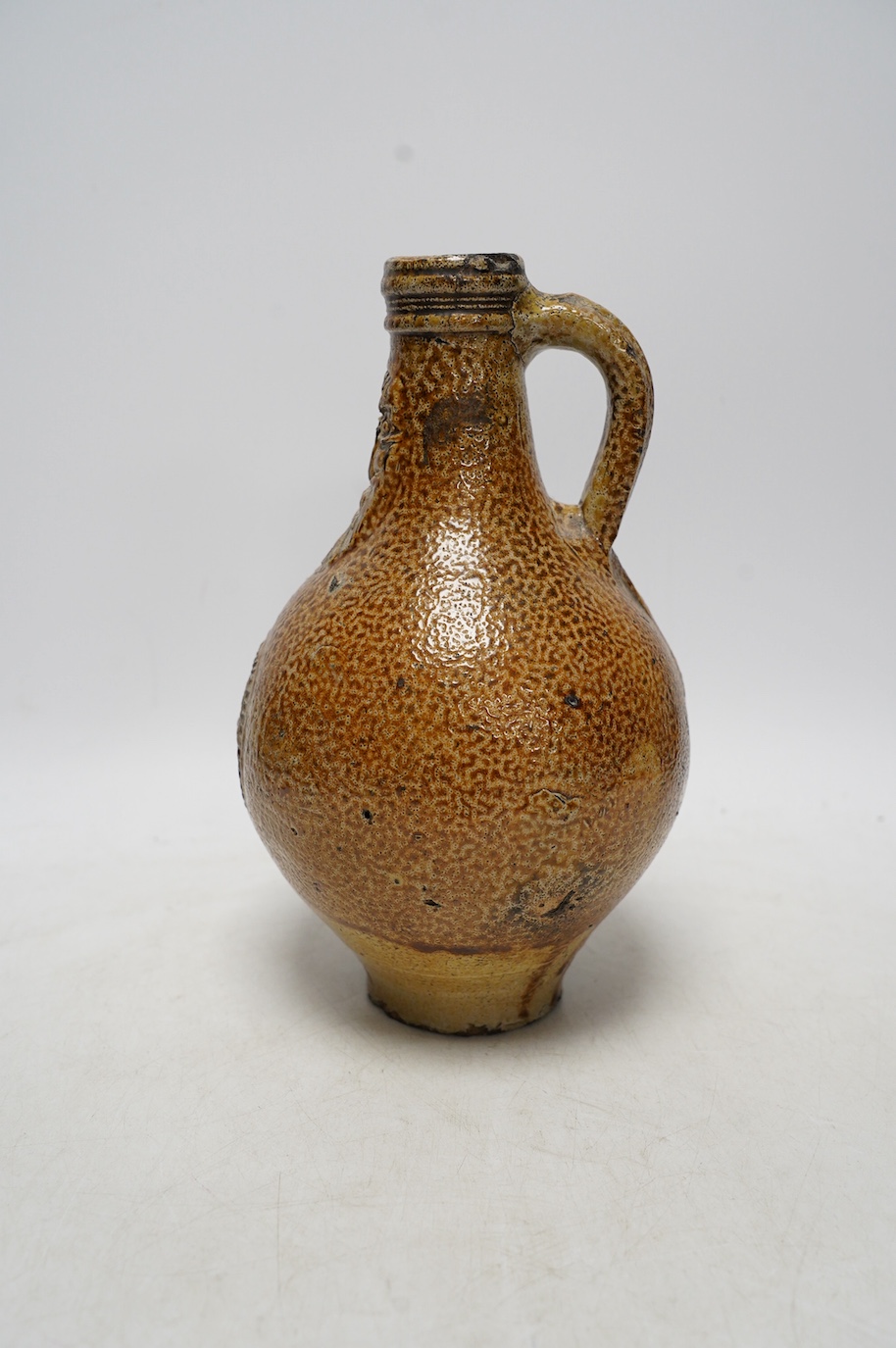 A 17th century Rhenish saltglazed Bellarmine, 23cm. Condition - commensurate with age